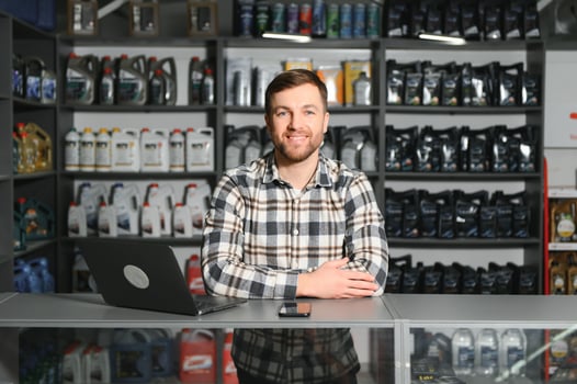Auto parts store. The seller receives the product and evaluates the quality photo