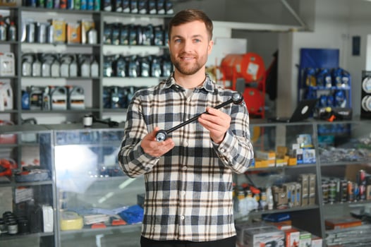 Portrait of a handsome salesman in an auto parts store. The concept of car repair photo