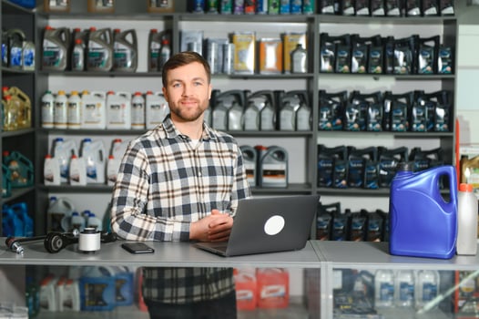 A salesman in an auto parts store. Retail trade of auto parts photo