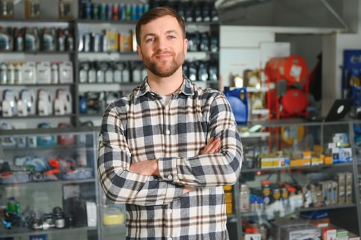 A salesman in an auto parts store. Retail trade of auto parts photo