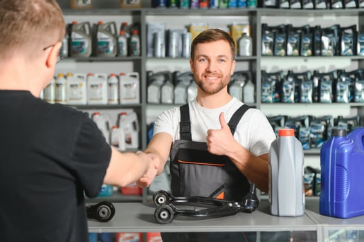 A customer speaks with a consultant at an auto parts store photo