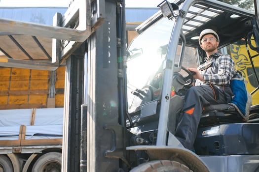 Portrait of heavy industry forklift driver giving thumbs up and smiling photo