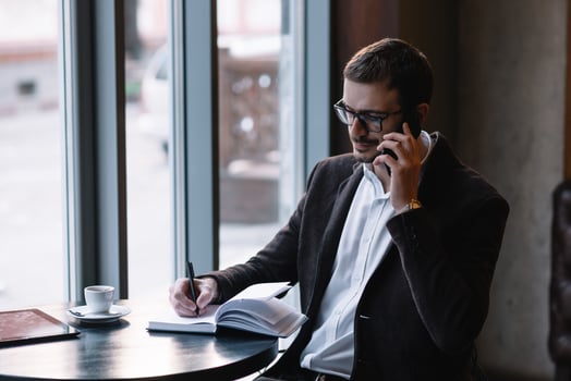 Handsome businessman talking on the phone in a cafe. photo