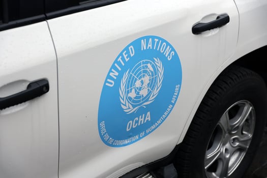 KYIV, UKRAINE - 4 MAY, 2023 Logo of UN United Nations OCHA on doors of white SUV car photo