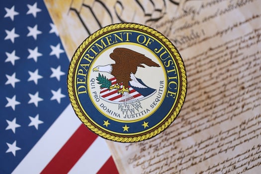 KYIV, UKRAINE - MARCH 9, 2024 US Department of Justice seal with United States Constitution on flag photo