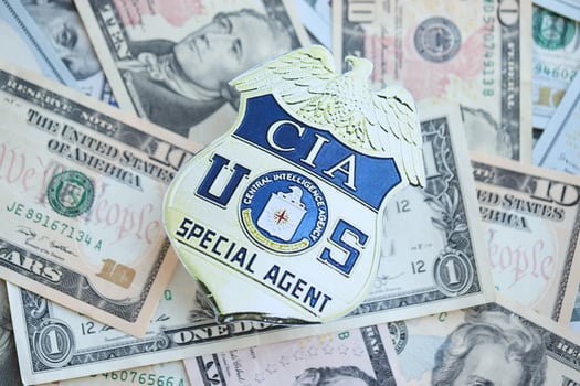 KYIV, UKRAINE - MARCH 9, 2024 US CIA Central Intelligence Agency badge on many US dollar bills photo