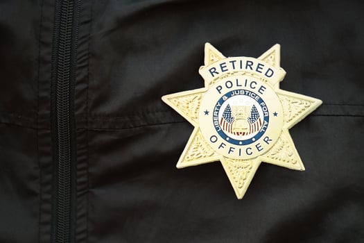 KYIV, UKRAINE - MARCH 9, 2024 US Retired Police Officer badge on black jacket uniform photo