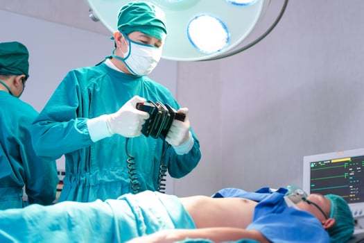 Medical team performing a surgical operation in the operating Room, Concentrated surgical team operating a patient photo