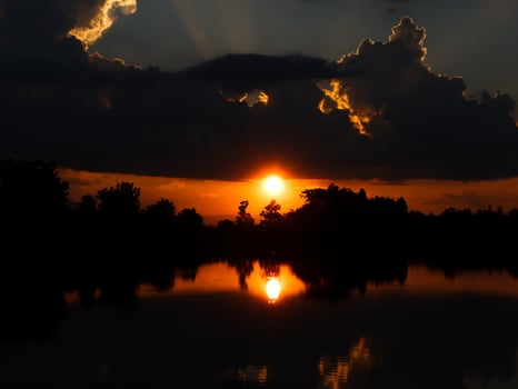 Spectacular sunset over, orange sun rising up over the horizon photo