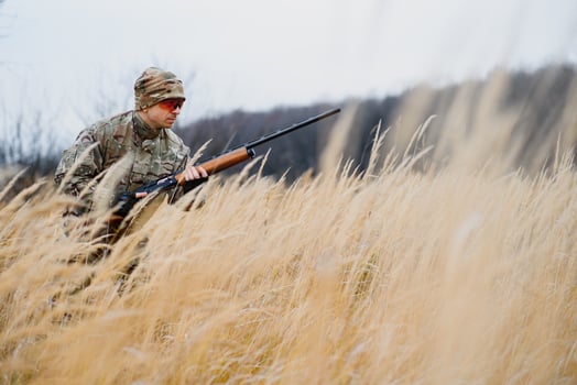 Hunting permit. Man brutal gamekeeper nature background. hunter spend leisure hunting. Hunter hold riffles. Focus and concentration of experienced hunter. Hunting and trapping seasons. photo