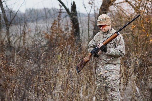 Hunting permit. Man brutal gamekeeper nature background. hunter spend leisure hunting. Hunter hold riffles. Focus and concentration of experienced hunter. Hunting and trapping seasons. photo