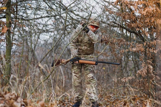 Hunting permit. Man brutal gamekeeper nature background. hunter spend leisure hunting. Hunter hold riffles. Focus and concentration of experienced hunter. Hunting and trapping seasons photo