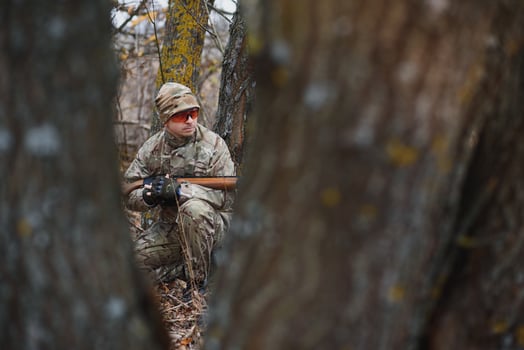 Hunter in uniform with a hunting rifle. Hunting Concept photo