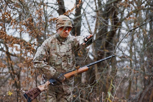 Hunter in uniform with a hunting rifle. Hunting Concept. photo