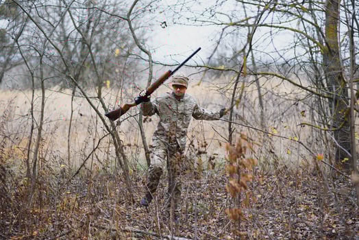 Hunting permit. Man brutal gamekeeper nature background. hunter spend leisure hunting. Hunter hold riffles. Focus and concentration of experienced hunter. Hunting and trapping seasons photo