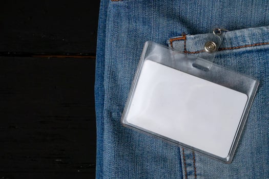 a white card is attached to the back pocket of a pair of jeans photo
