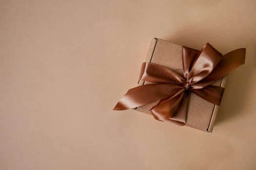 Brown gift box on beige background photo