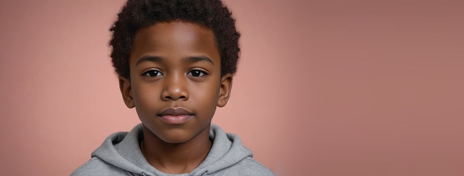 An African American Juvenile Boy Isolated On A Coral Background With Copy Space. photo