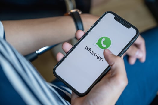 CHIANG MAI, THAILAND - FEB 1, 2032 . Man holding iPhone with Whatsapp logo on Cellphone Screen. photo
