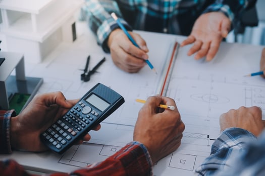 engineer people meeting working and pointing at a drawings in office for discussing. Engineering tools and construction concept. photo