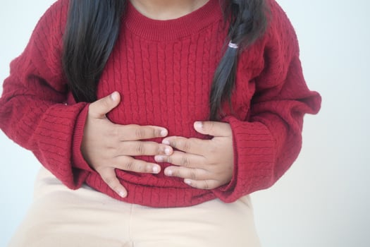 child suffering stomach pain close up. photo