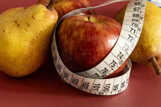 Tape measure and apple symbolizing diet and obesity photo
