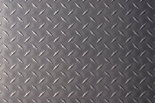 dark metal plate as background. steel texture with a rhombus pattern. photo