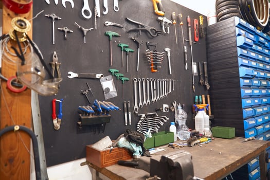 Stand with work tools in professional bicycle workshop photo