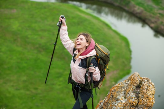 Young woman with backpack hiking in the mountains. Hiking concept. Trekking cliffs. Travel, traveler. photo