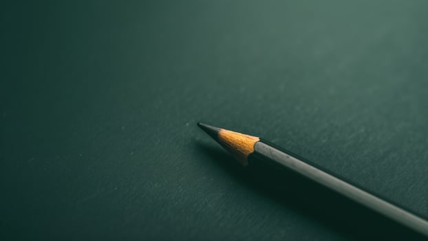Pencil on a black background. Close-up. Selective focus. photo