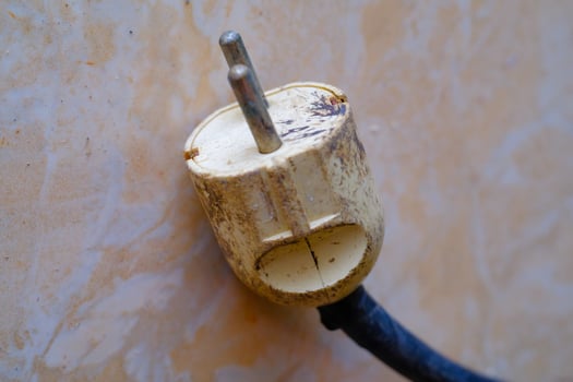 Industrial Photography. Construction Tools. Isolated worn electric plug with blue wire. A cable plug on the floor. Bandung, Indonesia photo