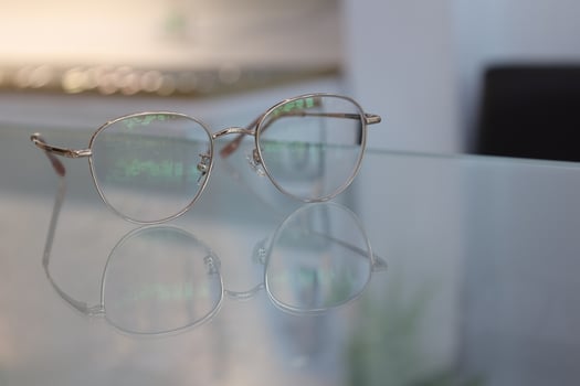 Eyeglasses on table, progressive lenses, eyeglasses for the elderly, glasses progressive lens, eyeglass progressive lens, close-up of glasses on lenses test, looking through glasses photo