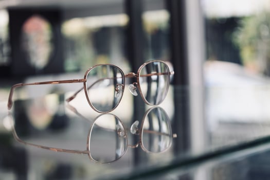 Eyeglasses on table, progressive lenses, eyeglasses for the elderly, glasses progressive lens, eyeglass progressive lens, close-up of glasses on lenses test, looking through glasses photo