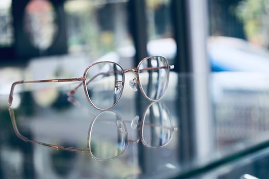 Eyeglasses on table, progressive lenses, eyeglasses for the elderly, glasses progressive lens, eyeglass progressive lens, close-up of glasses on lenses test, looking through glasses photo