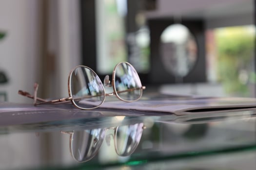 Eyeglasses on table, progressive lenses, eyeglasses for the elderly, glasses progressive lens, eyeglass progressive lens, close-up of glasses on lenses test, looking through glasses photo