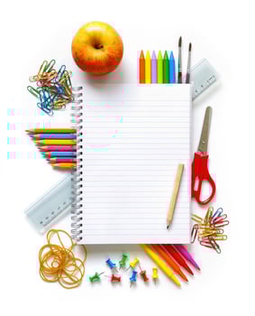 school stationery isolated on white, a notebook with pens, pencils, apple photo
