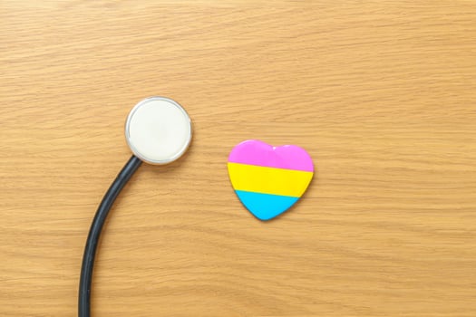Pansexual Pride Day and LGBT pride month concept. pink, yellow and blue heart shape with Stethoscope for Lesbian, Gay, Bisexual, Transgender, Queer and Pansexual community photo