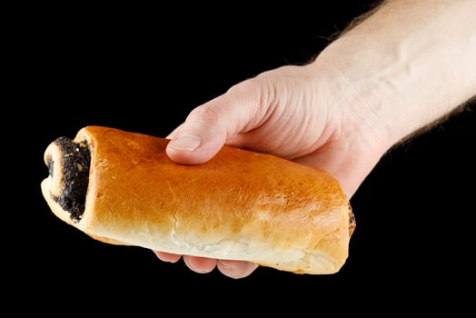 Poppy bun in hand close-up photo