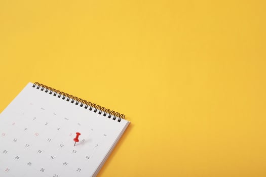 mark the event day with a pin. Thumbtack in calendar concept for busy timeline organize schedule,appointment meeting reminder. planning business meeting or travel holiday planning concept. soft focus photo