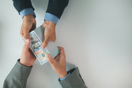 Real estate brokers are bribing government officials with cash issue construction permits in areas where high rise buildings are prohibited. Concept bribing government officials to facilitate business photo