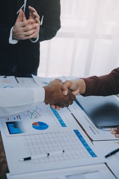 Real estate agent and customers shaking hands together celebrating finished contract after about home insurance and investment loan, handshake and successful deal. photo