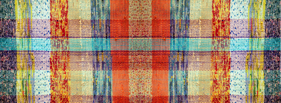 Antique handmade homespun carpet. The texture of an antique rug made of multicolored strips of fabric photo