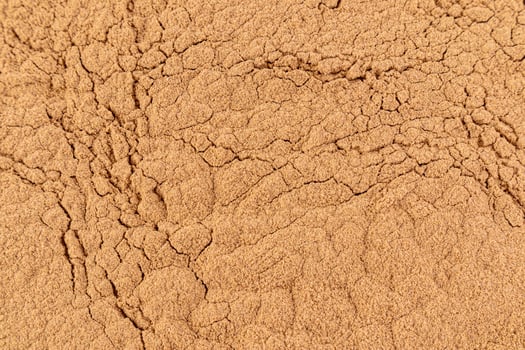 Gorgeous texture of bronze loose powder. Close Up Image. Embossed texture. Cosmetic background. Layout for design. photo