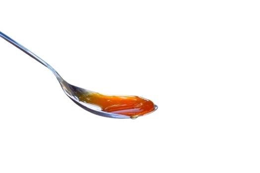 Spoon of honey isolated on white background photo