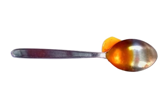 Spoon of honey isolated on white background photo