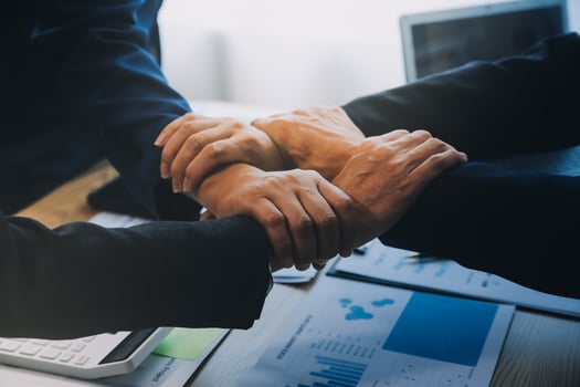 Business people join hands to join forces as a teamwork. photo