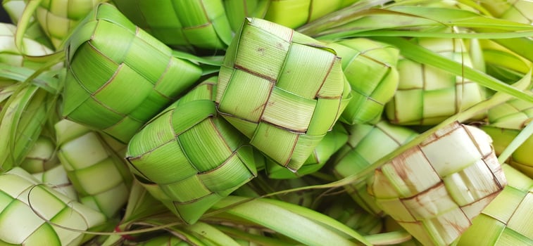 Ketupat or rice dumpling. A traditional rice casing made from young coconut leaves for cooking rice sold in traditional market preparation for the Eid al-Fitr holiday for Muslim photo