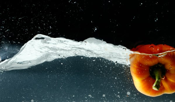 splashing bellpepper in water photo