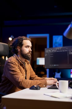 Cybersecurity professional using computer to look for company security vulnerabilities and dangerous malware. Programmer typing on keyboard, installing fortified code on PC to prevent cyber attacks photo
