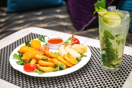 Deliciously Prepared Plate of Food and Refreshing Drink on Table photo